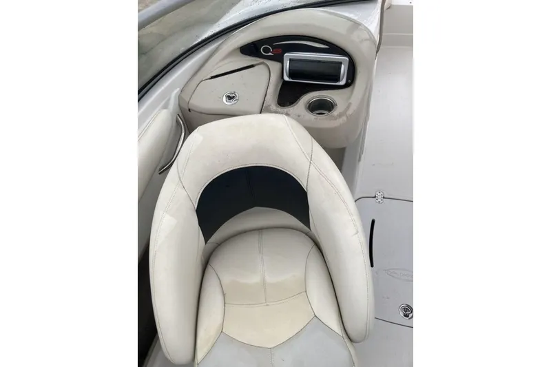 Slide: The Image of 2012 Tahoe Q8 SSi boat interior with beige seating and dashboard controls. - 7