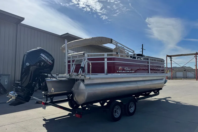Slide: The Image of 2024 Sun Tracker Party Barge 20 DLX pontoon boat with Mercury engine on trailer. - 2