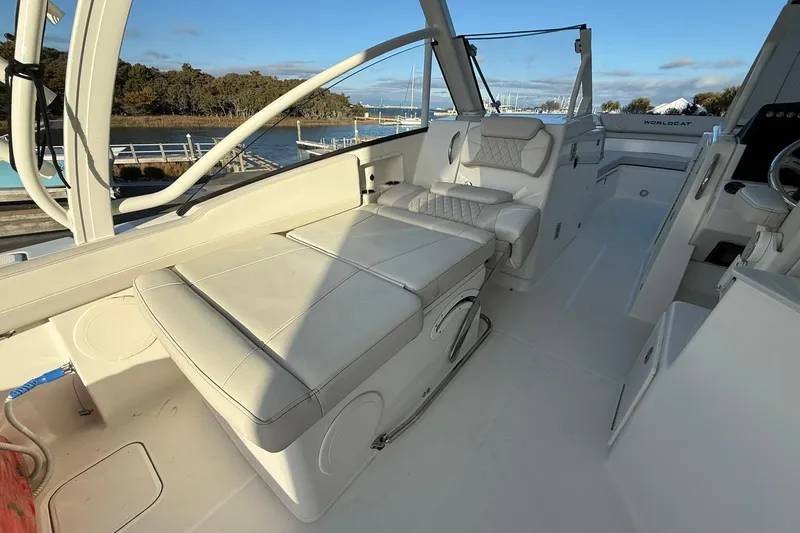 Slide: The Image of 2024 World Cat 280 DC-X boat interior with white seating and open deck view. - 11
