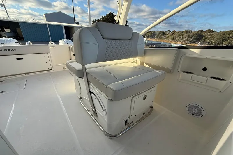 Slide: The Image of 2024 World Cat 280 DC-X boat interior with cushioned seating and storage compartments. - 13