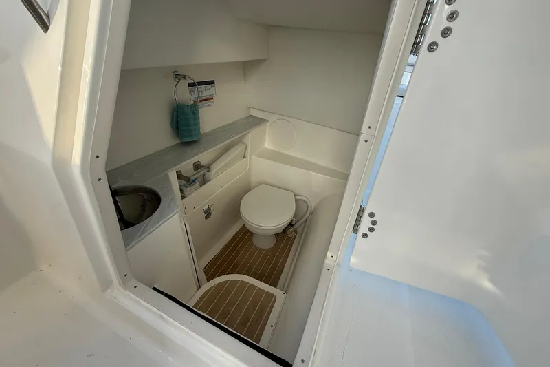 Slide: The Image of 2024 World Cat 280 DC-X boat interior bathroom with sink and toilet. - 14