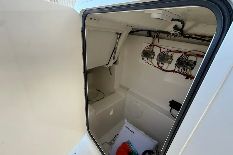 Slide: The Image of 2024 World Cat 280 DC-X boat storage compartment with wiring and equipment. - 15