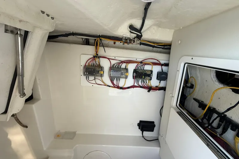Slide: The Image of Electrical wiring setup inside 2024 World Cat 280 DC-X boat compartment. - 16