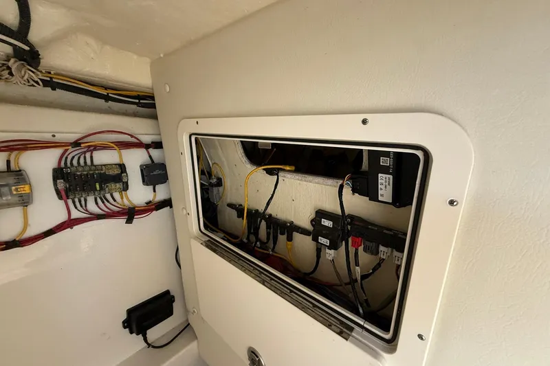 Slide: The Image of Electrical panel inside 2024 World Cat 280 DC-X boat, showcasing wiring and components. - 17