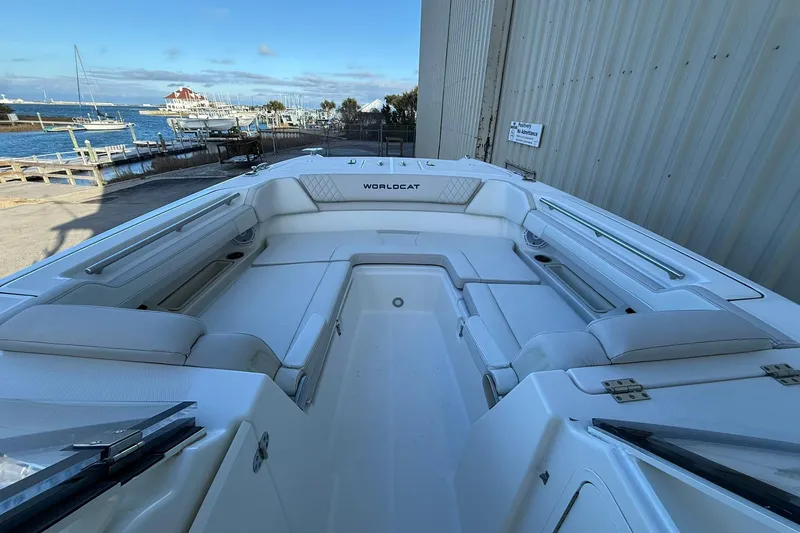 Slide: The Image of 2024 World Cat 280 DC-X boat interior with spacious seating, dockside view. - 19
