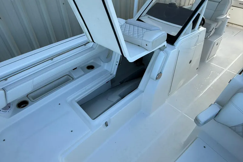 Slide: The Image of 2024 World Cat 280 DC-X boat interior with open storage compartment and seating. - 23