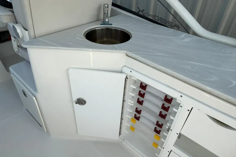 Slide: The Image of 2024 World Cat 280 DC-X boat interior with sink and storage compartments. - 26
