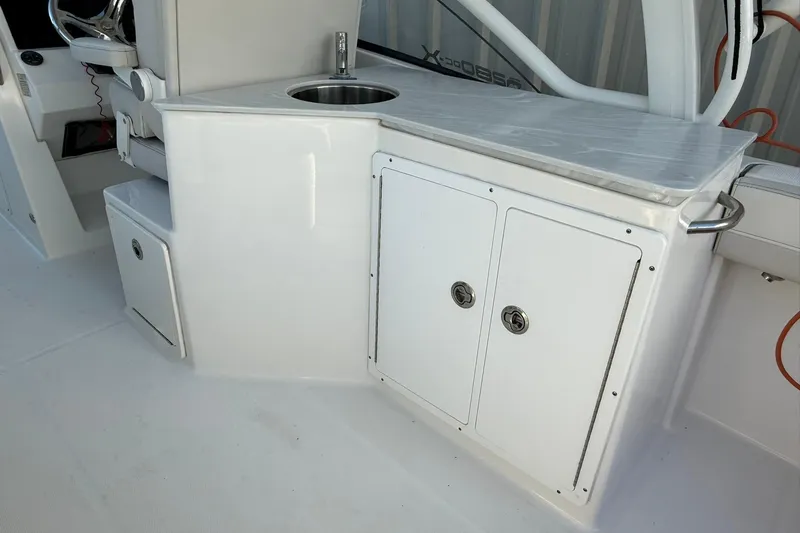 Slide: The Image of 2024 World Cat 280 DC-X boat interior with sink and storage cabinets. - 27
