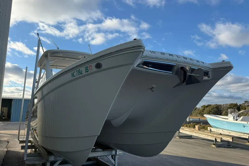 Slide: The Image of 2024 World Cat 280 DC-X boat on trailer under blue sky. - 3