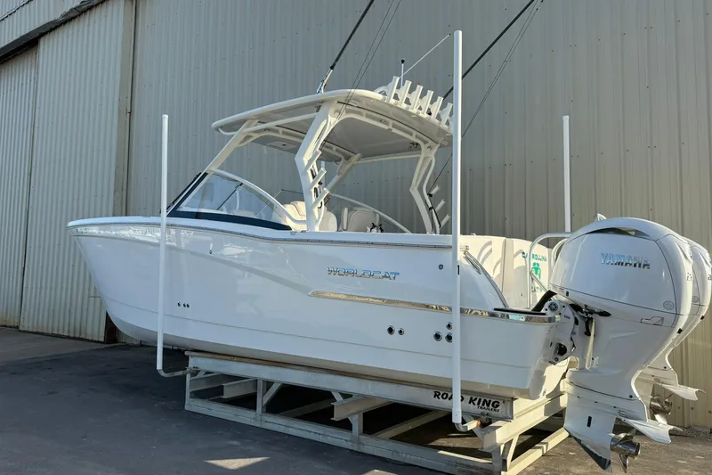 Slide: The Image of 2024 World Cat 280 DC-X boat with dual Yamaha engines, displayed on a trailer. - 4