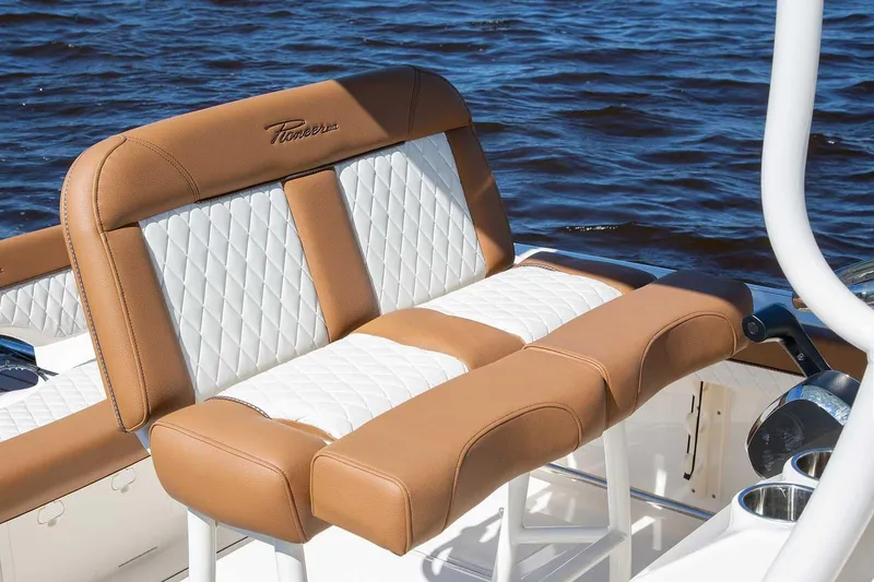 Slide: The Image of Manufacturer Provided Image: Luxurious seating on 2025 Pioneer 222 Islander boat with quilted design, near water. - 10