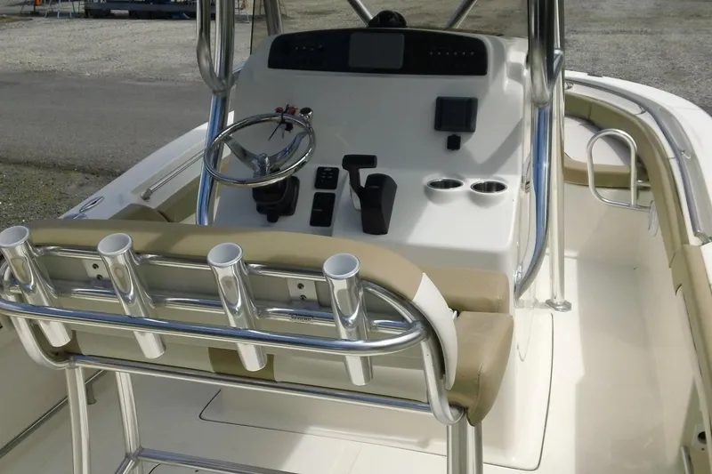 Slide: The Image of 2026 Pioneer 222 Islander boat console with steering wheel and rod holders. - 13