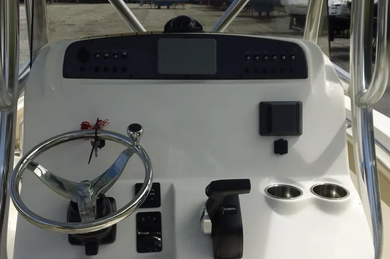Slide: The Image of 2026 Pioneer 222 Islander boat dashboard with steering wheel and controls. - 14