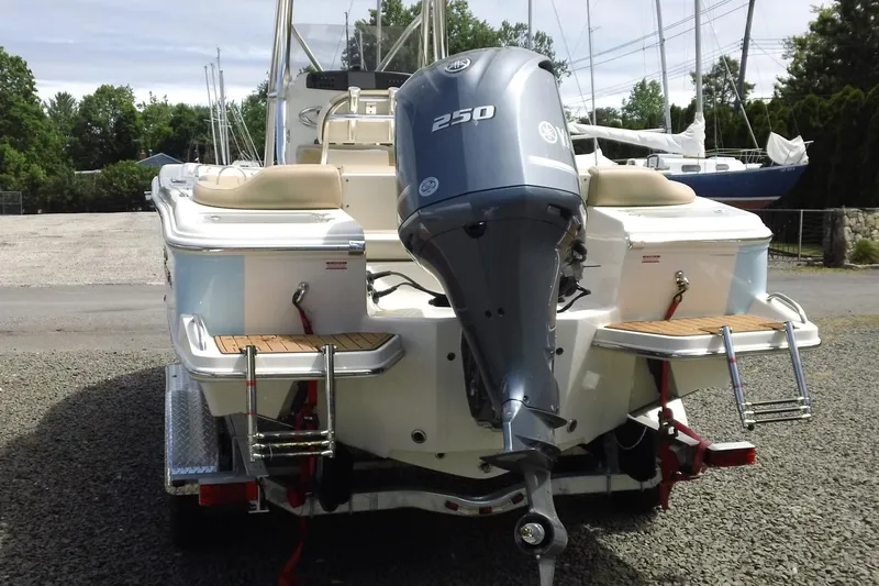 Slide: The Image of 2026 Pioneer 222 Islander boat with powerful outboard motor, parked on a trailer. - 25