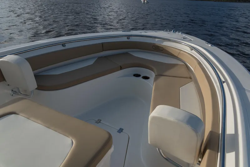 Slide: The Image of 2026 Pioneer 222 Islander boat interior with beige seating, on calm water. - 8