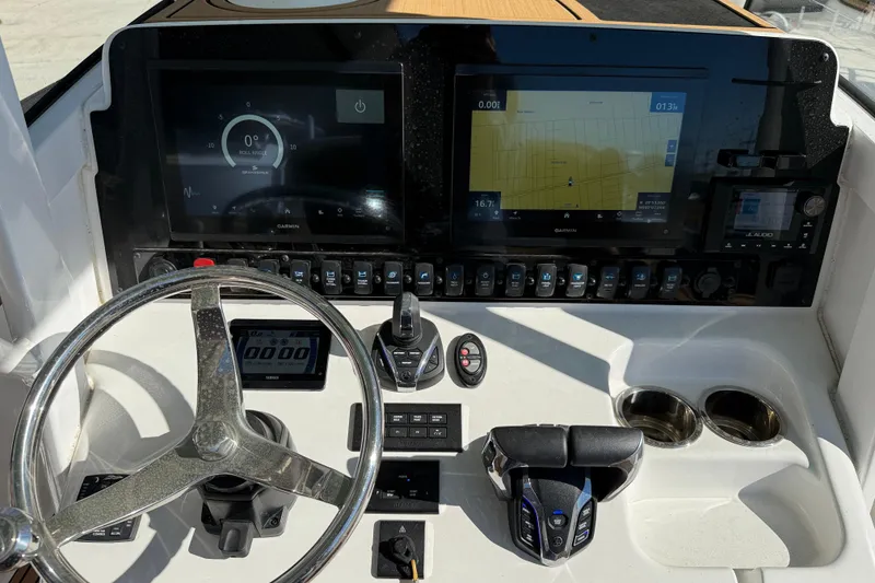 Slide: The Image of 2024 Sea Hunt Gamefish 27 dashboard with advanced navigation and control systems. - 14