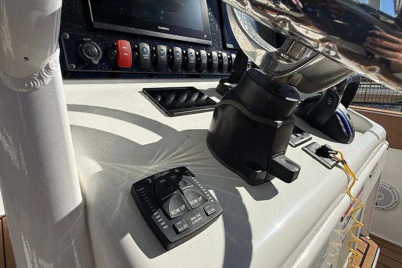 Slide: The Image of 2024 Sea Hunt Gamefish 27 dashboard with steering wheel and control panel. - 16