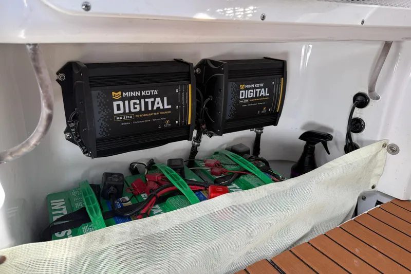 Slide: The Image of 2024 Sea Hunt Gamefish 27 with Minn Kota digital battery chargers and batteries. - 19