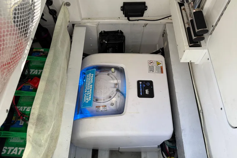 Slide: The Image of 2024 Sea Hunt Gamefish 27 boat equipment compartment with Seakeeper unit and batteries. - 20