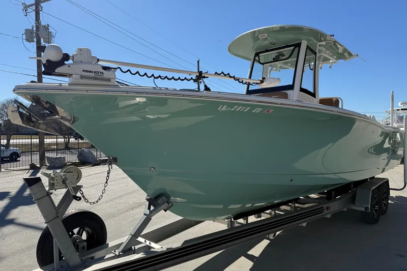 Slide: The Image of 2024 Sea Hunt Gamefish 27 boat on trailer, featuring Minn Kota trolling motor. - 3
