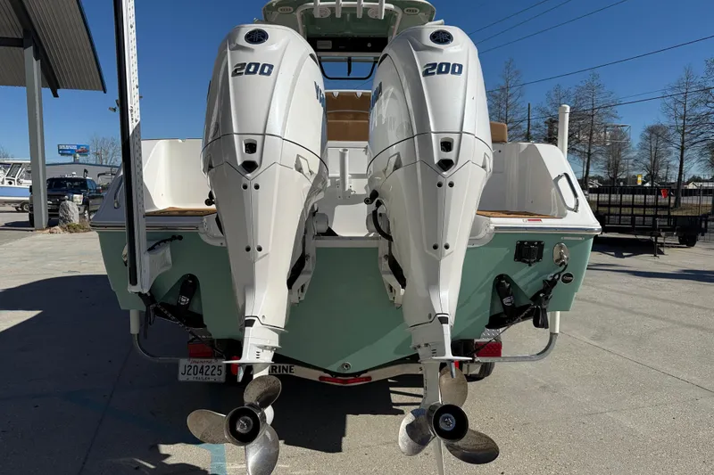 Slide: The Image of 2024 Sea Hunt Gamefish 27 with dual 200 horsepower engines, docked outdoors. - 5