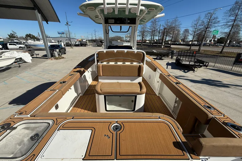 Slide: The Image of 2024 Sea Hunt Gamefish 27 boat interior with tan seating and wood accents. - 7