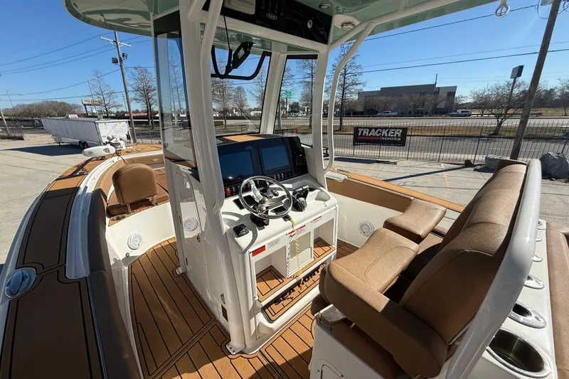 Slide: The Image of 2024 Sea Hunt Gamefish 27 boat interior with modern helm and seating. - 8