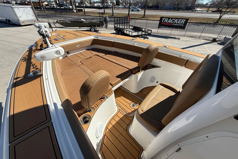 Slide: The Image of 2024 Sea Hunt Gamefish 27 boat interior with tan seating and wood accents. - 9