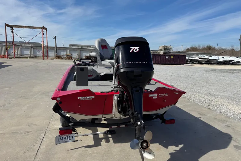 Slide: The Image of 2013 Tracker Pro Team 175 TXW boat with 75 HP engine, parked outdoors. - 2