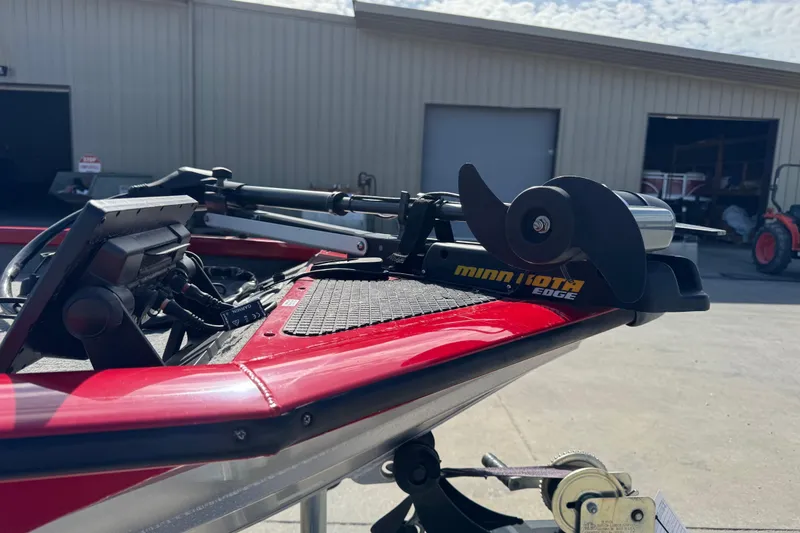 Slide: The Image of 2013 Tracker Pro Team 175 TXW with Minn Kota Edge trolling motor in a garage setting. - 8