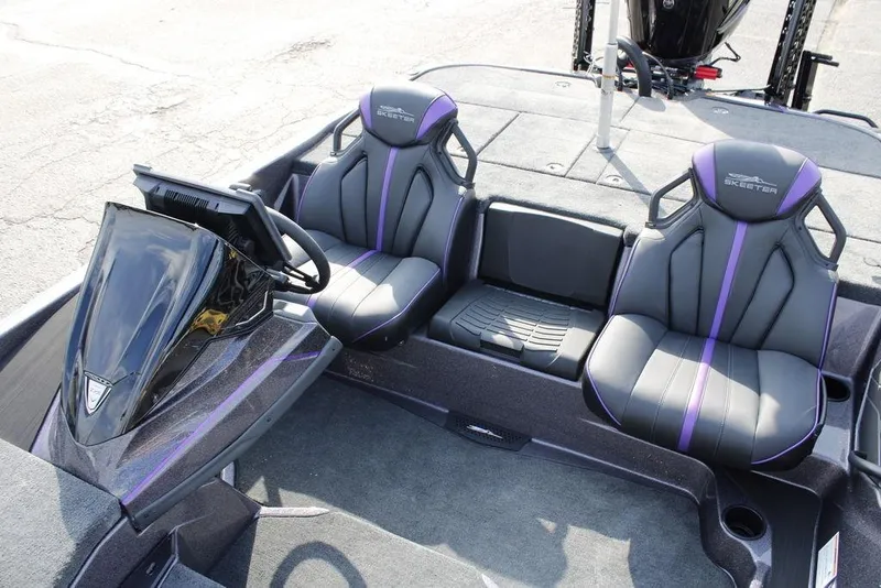 Slide: The Image of 2026 Skeeter ZXE20 boat interior with sleek black and purple seats, modern dashboard. - 13