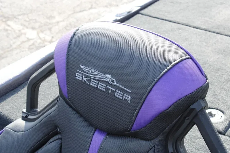 Slide: The Image of 2026 Skeeter ZXE20 boat seat with purple and gray design, featuring Skeeter logo. - 17