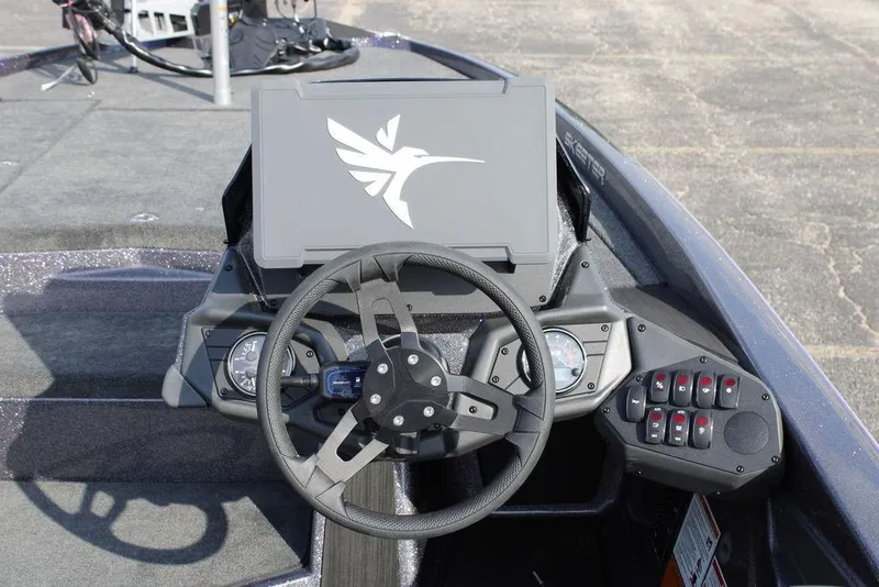 Slide: The Image of 2026 Skeeter ZXE20 boat dashboard with steering wheel and control panel. - 19