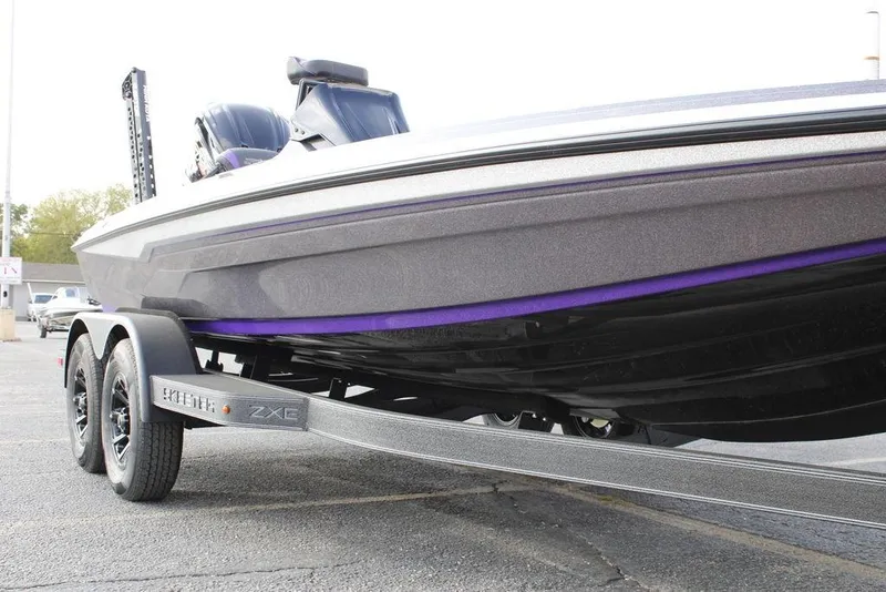 Slide: The Image of 2026 Skeeter ZXE20 boat on trailer, showcasing sleek design and dual axles. - 25