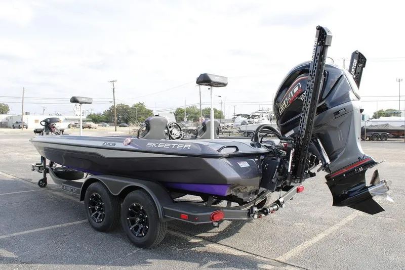 Slide: The Image of 2026 Skeeter ZXE20 boat with powerful outboard motor in a parking lot. - 27