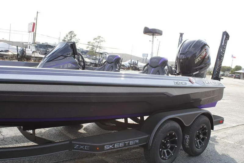Slide: The Image of 2026 Skeeter ZXE20 boat on trailer, featuring sleek design and powerful engine. - 4