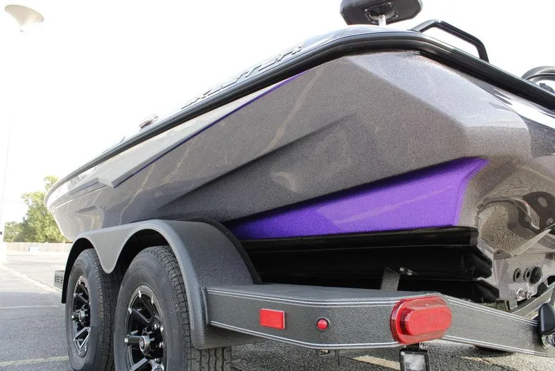 Slide: The Image of 2026 Skeeter ZXE20 boat on trailer, featuring sleek design and vibrant purple accents. - 5