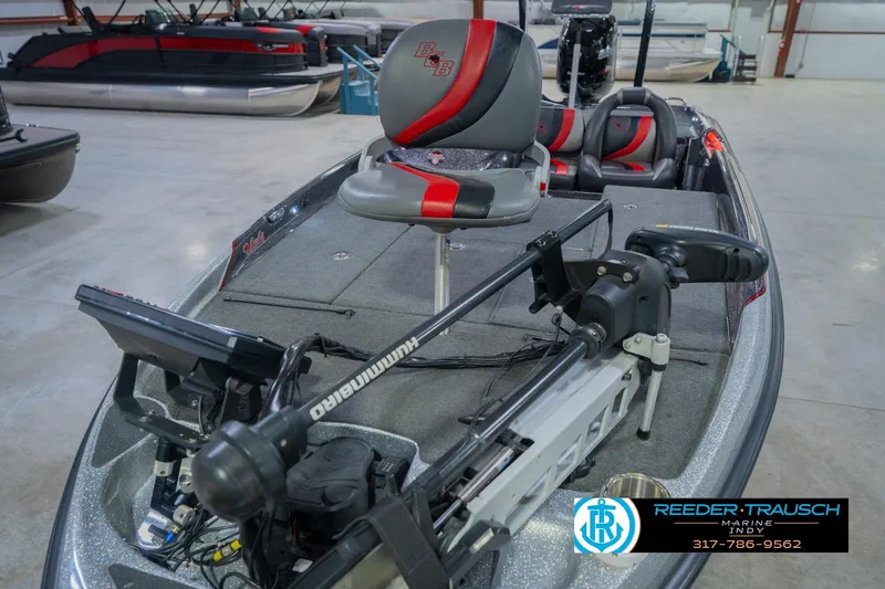 Slide: The Image of 2016 Bass Cat Cougar boat with advanced fishing equipment in a showroom. - 11