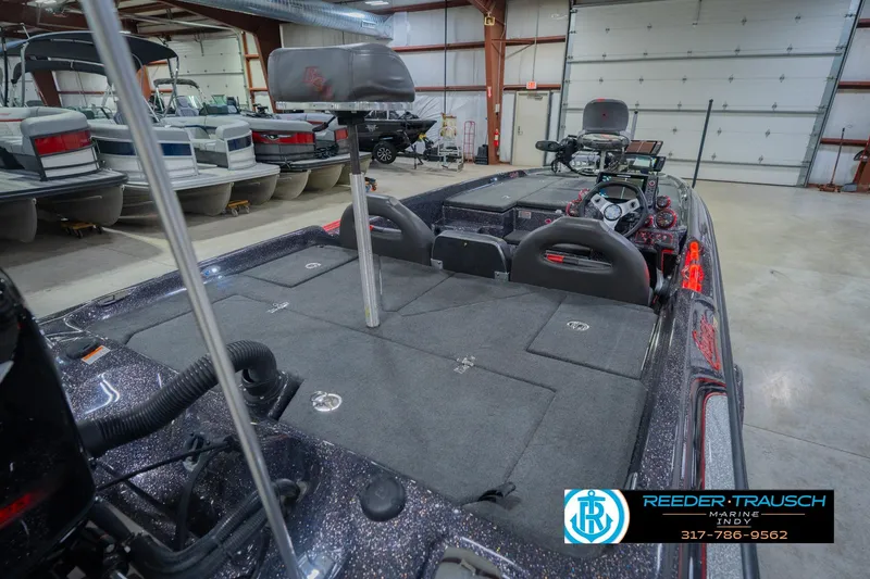 Slide: The Image of 2016 Bass Cat Cougar boat interior in showroom with fishing seats and controls. - 13