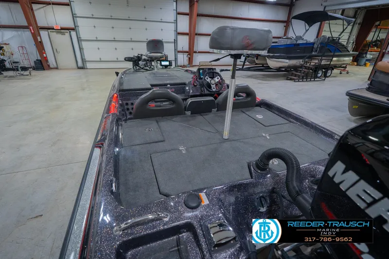 Slide: The Image of 2016 Bass Cat Cougar boat interior in a showroom, featuring seating and control panel. - 14