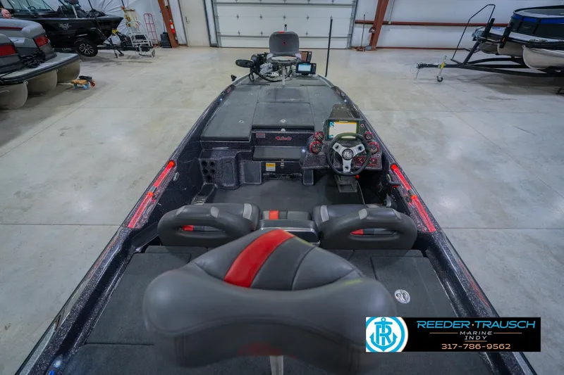 Slide: The Image of 2016 Bass Cat Cougar boat interior with steering console and seating in a showroom. - 15
