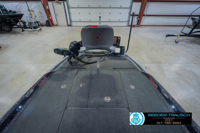 Slide: The Image of 2016 Bass Cat Cougar boat interior with fishing equipment in a spacious garage. - 17