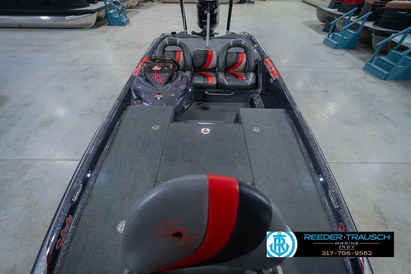 Slide: The Image of 2016 Bass Cat Cougar boat interior with gray and red seating, displayed in showroom. - 18