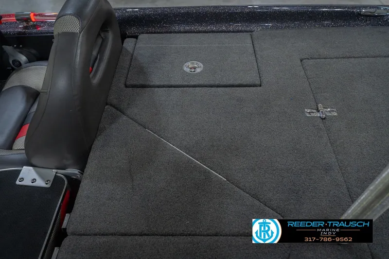 Slide: The Image of 2016 Bass Cat Cougar boat interior with carpeted storage compartments and seating. - 21