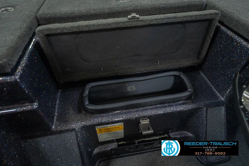 Slide: The Image of 2016 Bass Cat Cougar boat storage compartment with Reeder-Trausch Marine logo. - 24