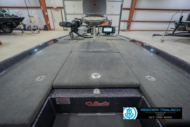 Slide: The Image of 2016 Bass Cat Cougar boat interior with fishing seat and control panel in a garage. - 25