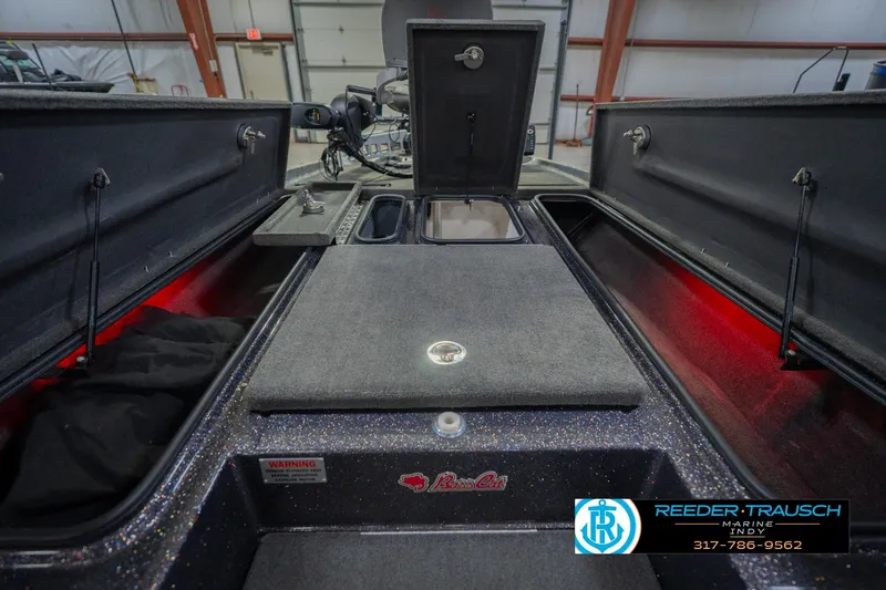 Slide: The Image of 2016 Bass Cat Cougar boat interior with storage compartments and Reeder-Trausch Marine logo. - 27
