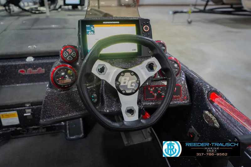 Slide: The Image of Interior view of a 2016 Bass Cat Cougar boat with controls. - 29