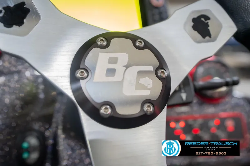 Slide: The Image of Steering wheel of 2016 Bass Cat Cougar boat with BC logo and Reeder-Trausch Marine branding. - 30