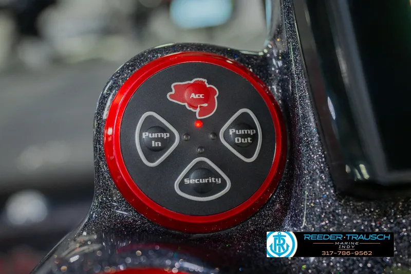 Slide: The Image of Control panel of a 2016 Bass Cat Cougar boat with pump and security buttons. - 32